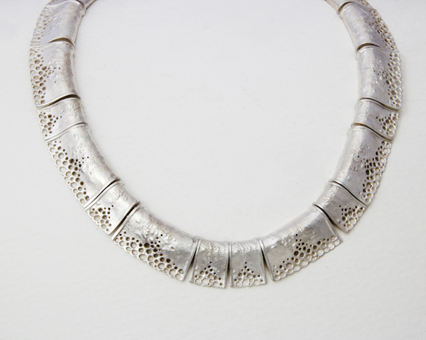 Large silver necklace with pieced and textured segment 